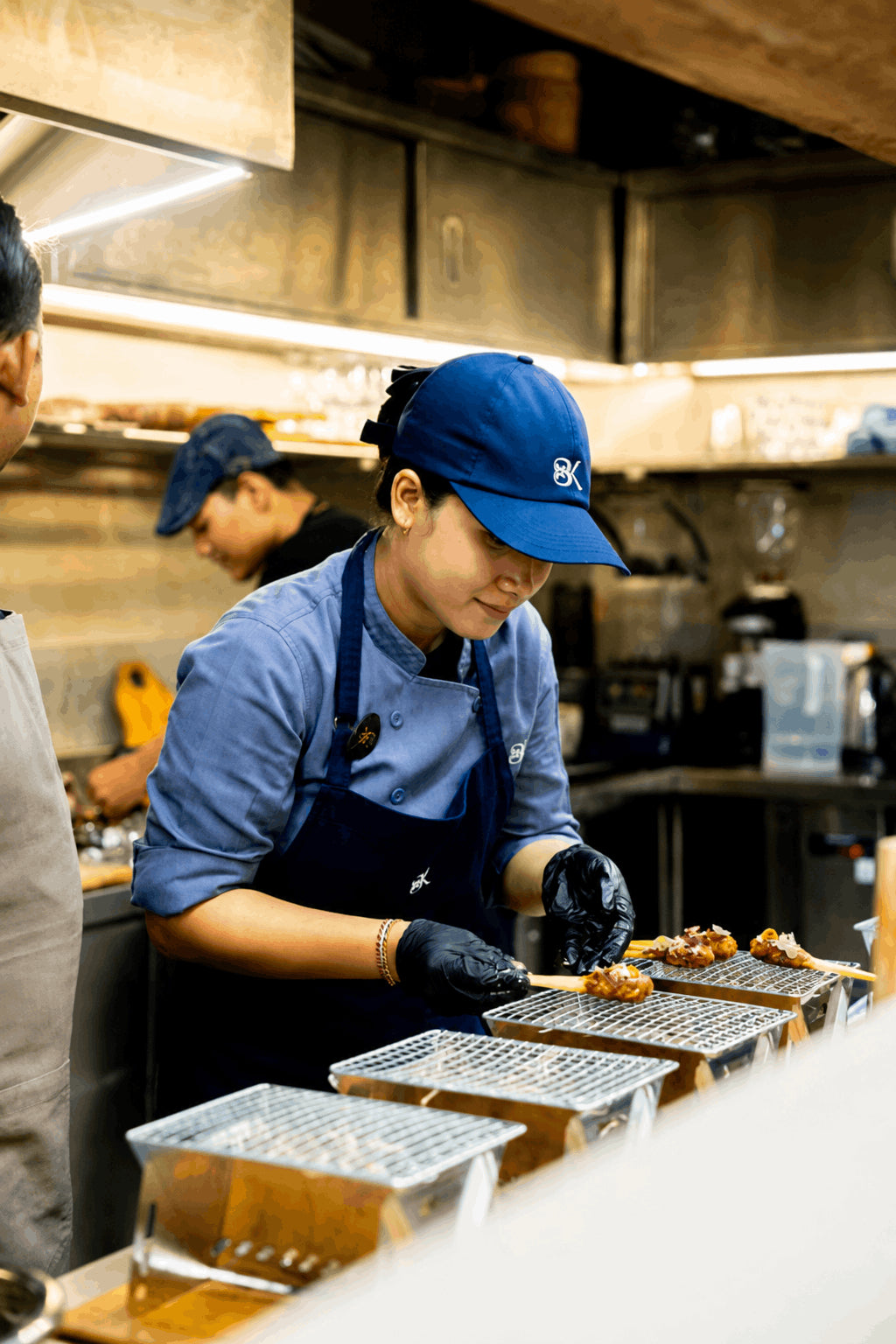 Cook preparing skewers in the café kitchen