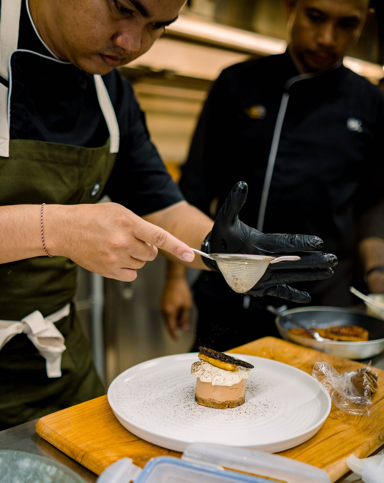 Cook straining a sauce