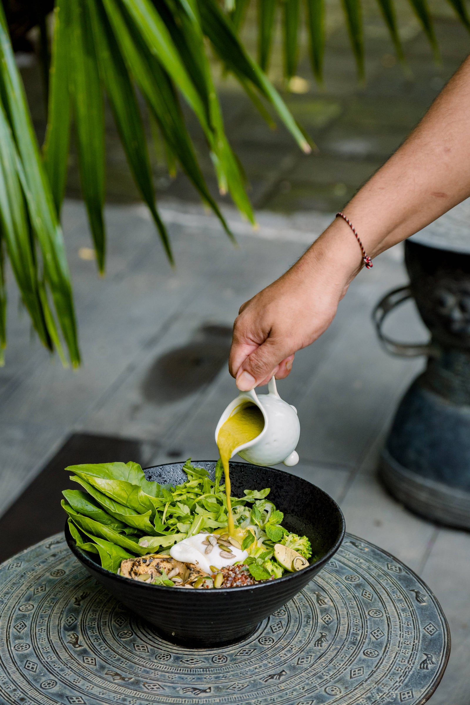 Dressing poured over a fresh salad