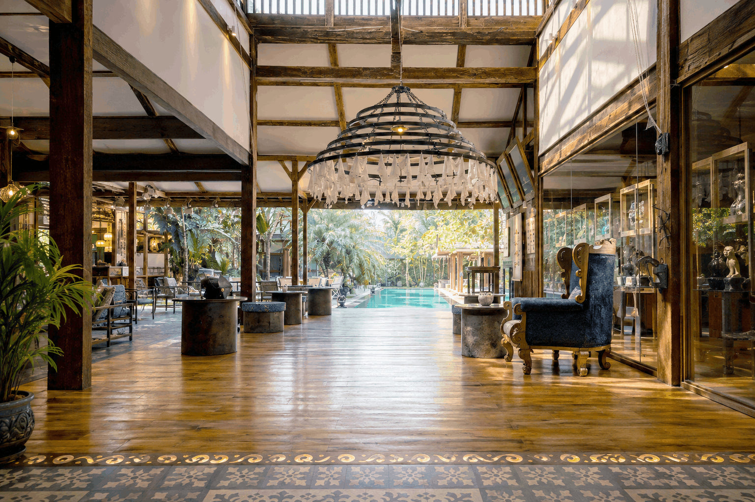 Open-air terrace of the Art Café with a pool and tropical garden